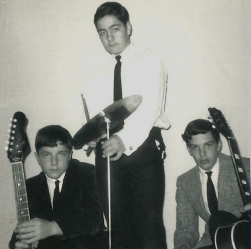 (Image: Publicity Pose Against a White Backdrop
 with the Band Members Wearing Suits and Ties)